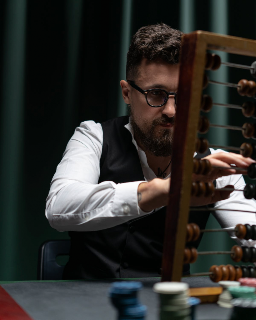 Man using abacus to calculate.